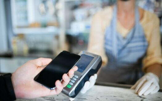 Contactless payment with smartphone, coffee shop open after lockdown